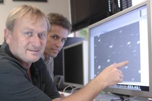 Richard Wainscoat (left) and Marco Micheli study one of the near-Earth asteroids found on Jan. 29.