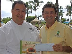 Chef Tylun Pang presents Chris Speere of MCA with the first check. 