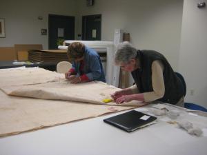 Moana Eisele, at left, and Mary Wood Lee stabilize cultural materials in Hulihee Palace.