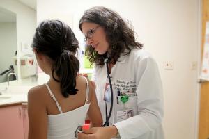 UH Family Medicine Resident Kelly Makino, MD, examines a child at Mililani Physician Center.
