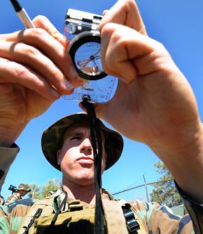 <p><strong>Fig. 8.26.</strong> (<strong>B</strong>) A sailor uses a magnetic compass to navigate along a shoreline.</p>