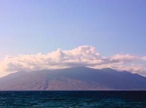 <p><strong>Fig. 8.5.</strong> (<strong>A</strong>) Clouds form over land because of the elevation and temperature differences between land and the ocean. This picture is of the high island of Moloka‘i, Hawai‘i.</p>
