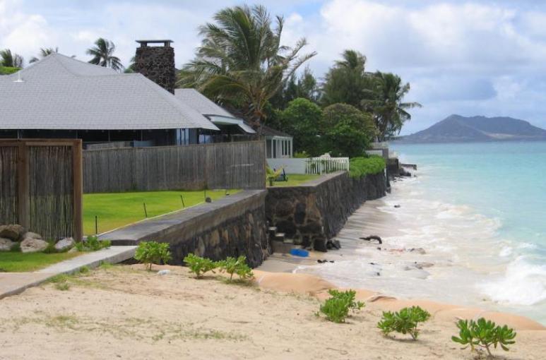 <p>Fig. 3.&nbsp;Coastal erosion and “hard armoring” using sea walls has resulted in stretches of shoreline that have no beach, such as this location at Lanikai, O‘ahu.</p>
