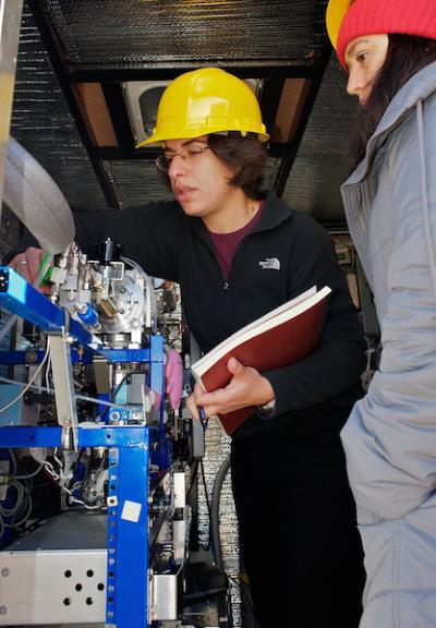 <p>Fig. 2.&nbsp;NOAA scientists inspect an instrument that samples particles in the atmosphere.</p>